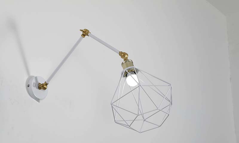 Adjustable swing-arm wall lighting